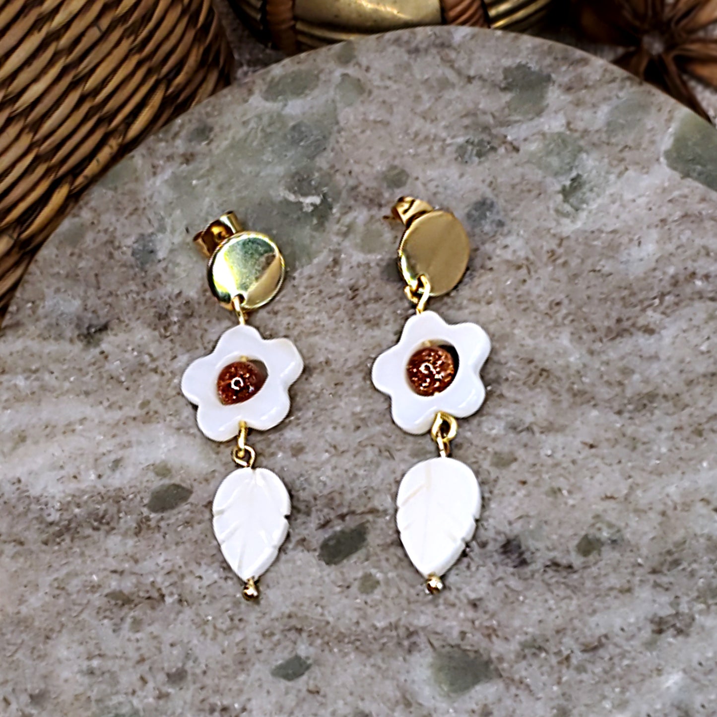 White daisy dangling earrings with sparkling sandstone bead on center.