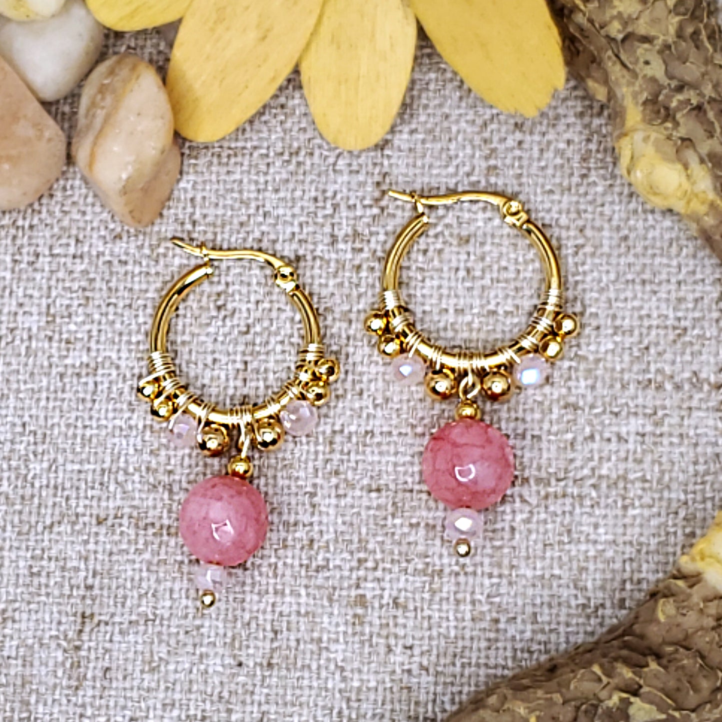 Small gold dangling hoop earrings with faceted quartz pink jade bead.