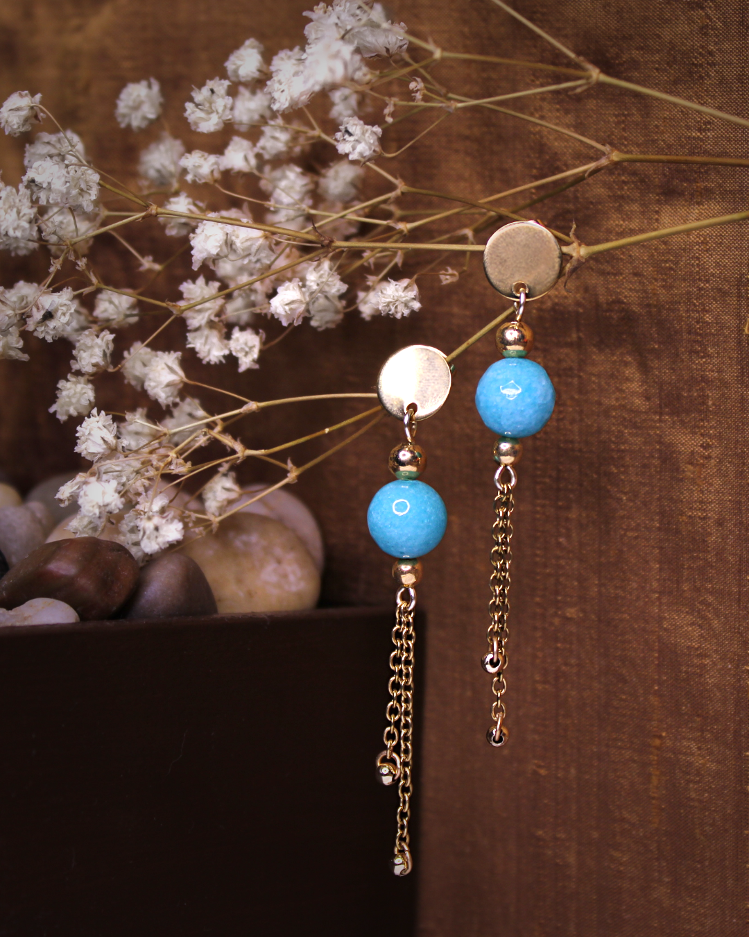 Gold plated stainless steel circle stud earrings with faceted light blue jade bead and gold plated chain accent.