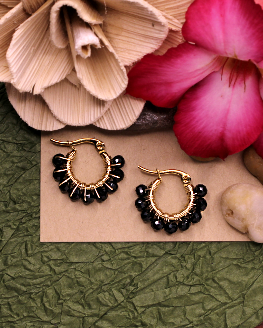 Mini stainless steel gold hoop earrings with black crystal beads. 