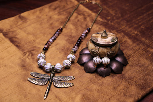 Antique gold dragonfly pendant necklace with bone white lantern like beads, brown and clear crackle crystal beads. Matching earrings. 