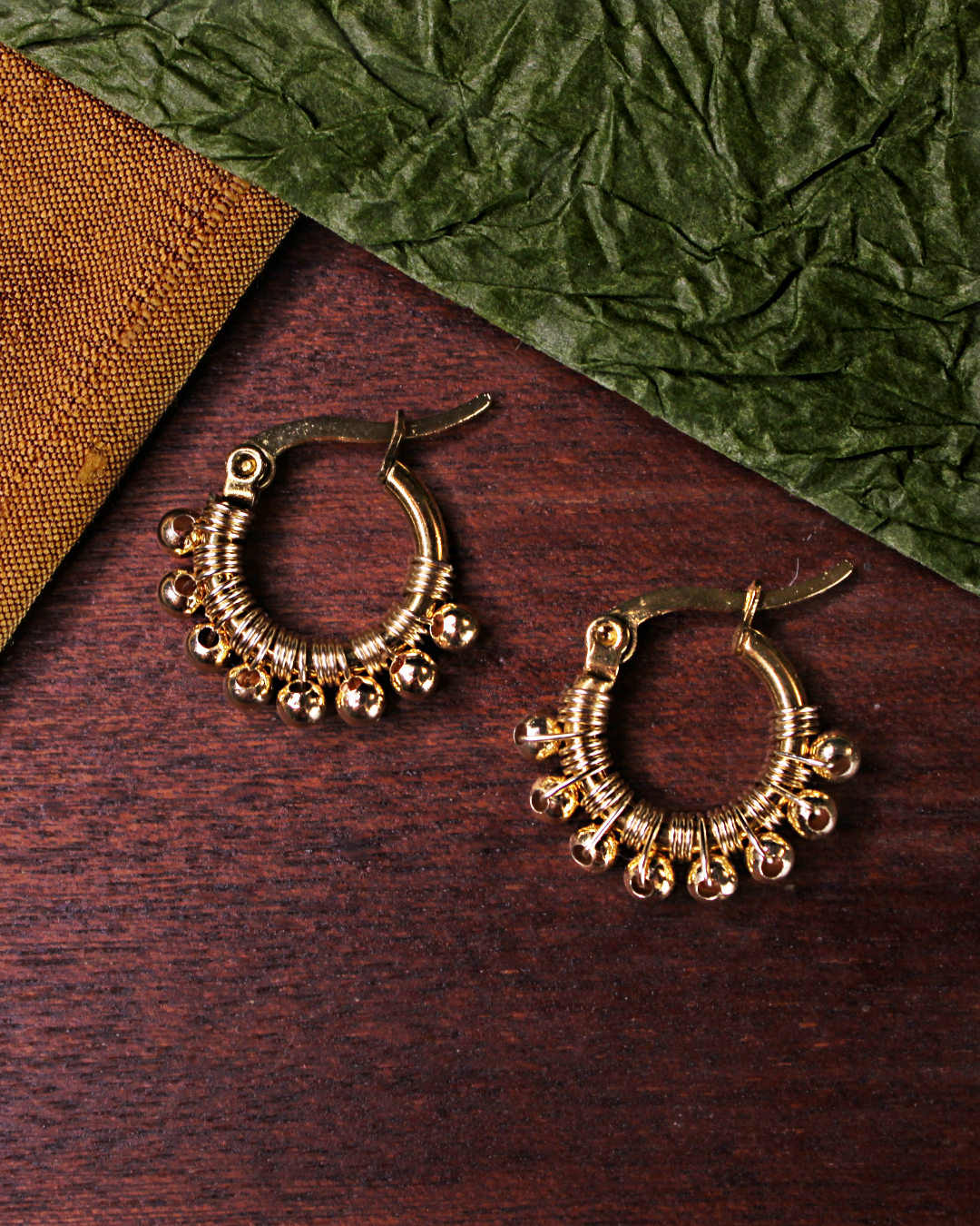 Mini hoop earrings gold hand wired with gold plated stainless steel beads. 