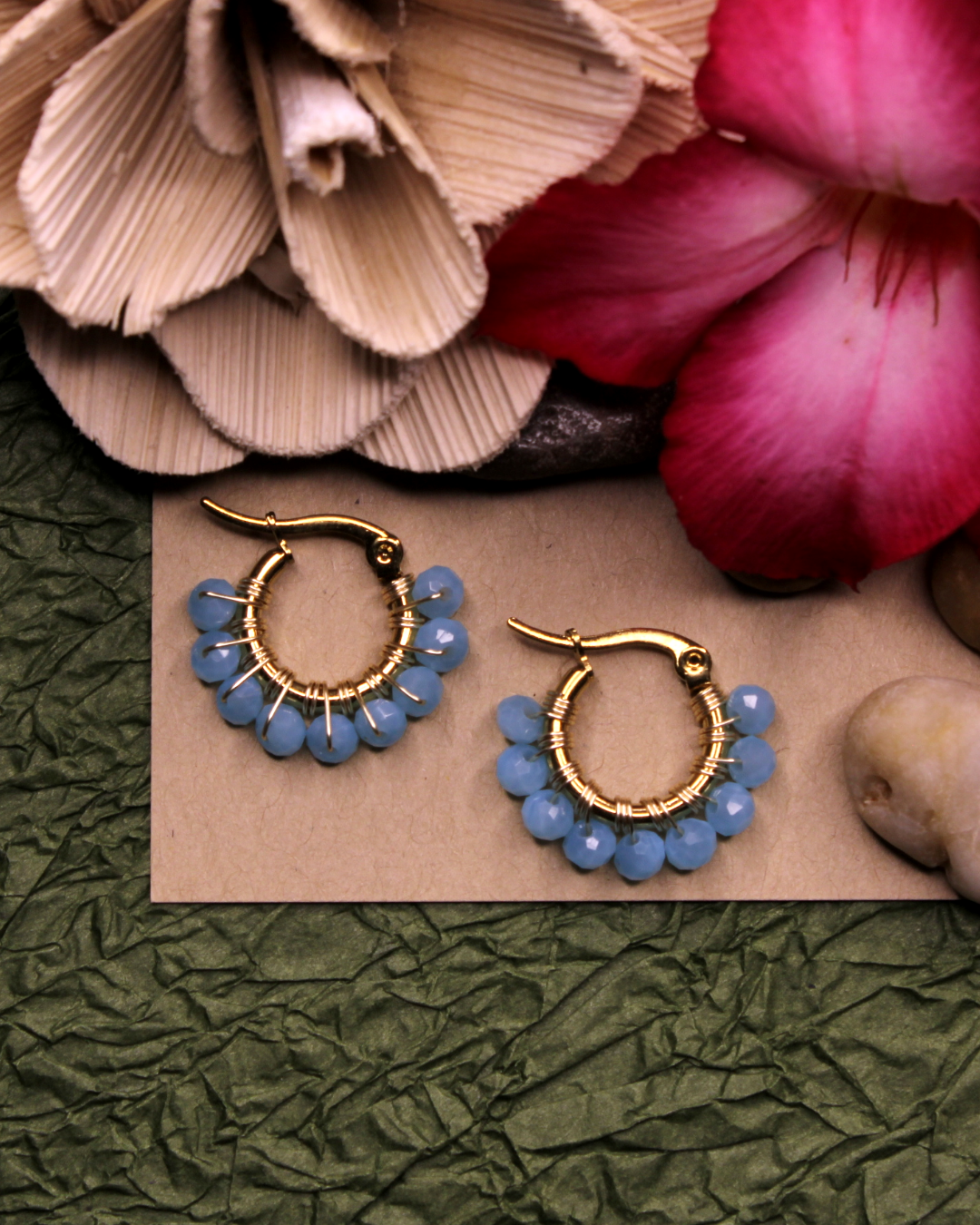 Mini stainless steel gold hoop earrings with cerulean blue crystal beads. 