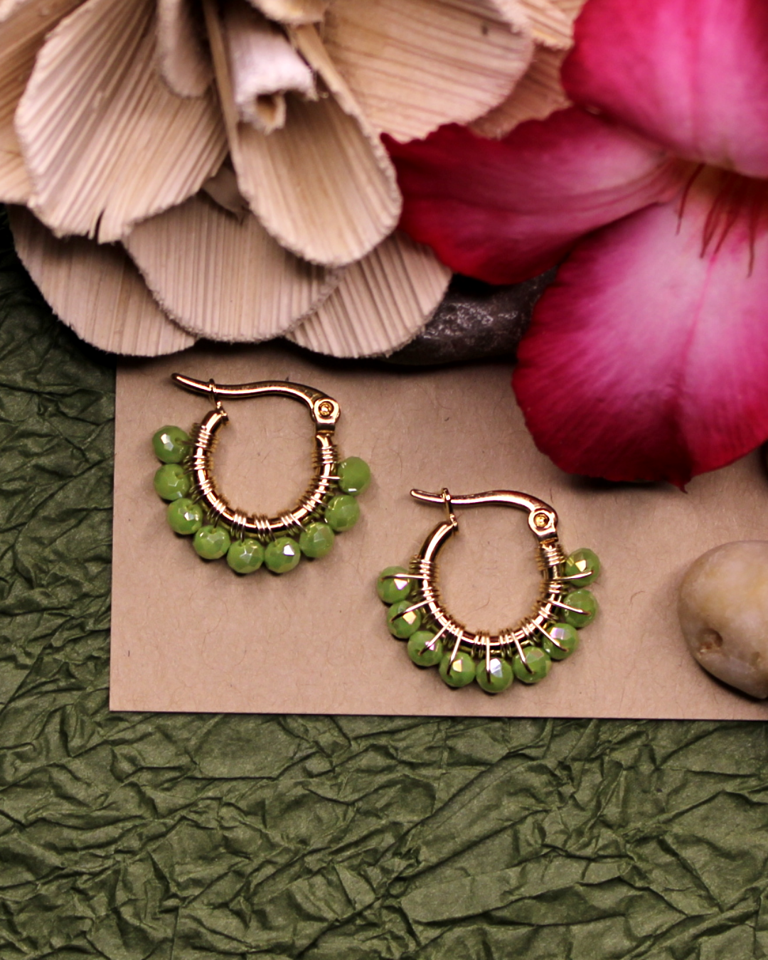 Mini stainless steel gold hoop earrings with light green crystal beads. 
