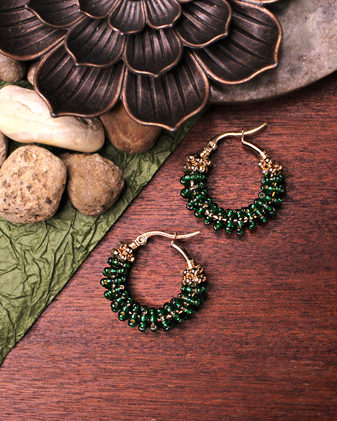Small stainless steel gold colored hoop  earrings with dark green crystal seed beads.