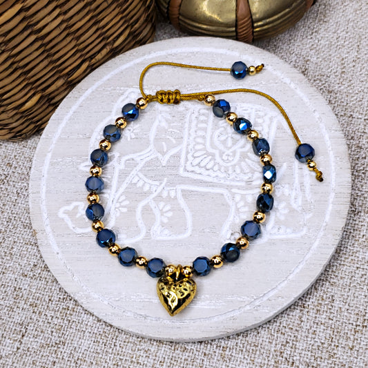 Gold hammered heart charm with blue crystal beads adjustable bracelet.