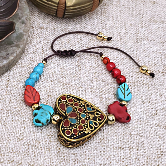 PeTRa'S ACCESSORIES Denia bracelet. Heart focal bead with red and turquoise colored elephant beads. Adjustable bracelet. 