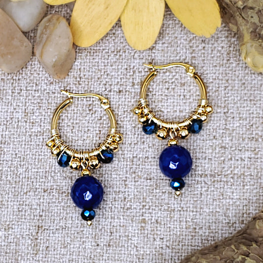 Small gold dangling hoop earrings with faceted royal blue jade bead. 